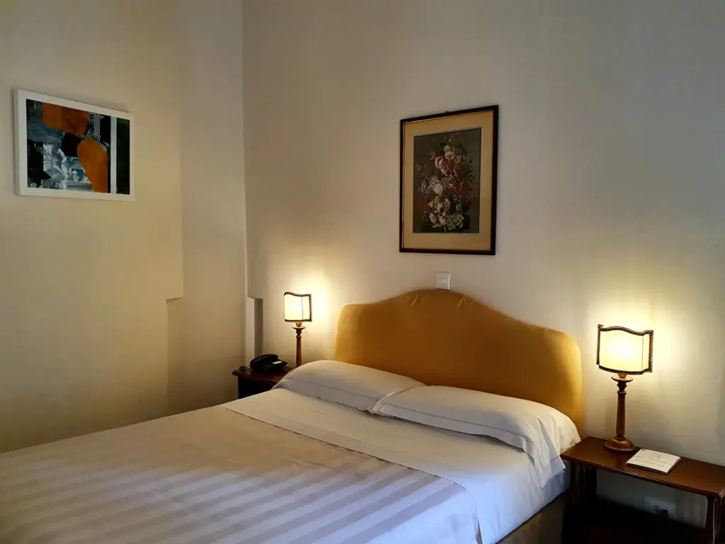 Double room with a yellow headboard and two bedside lamps