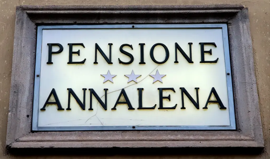 Historic sign reading Pensione Annalena with three stars