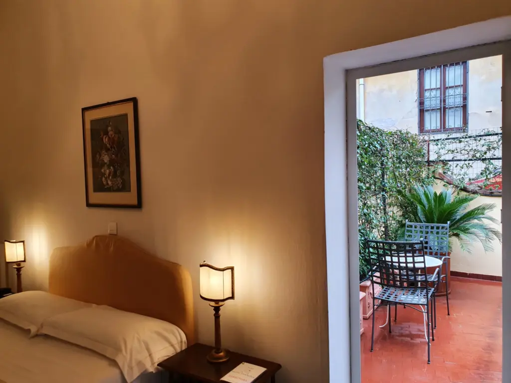 Double room with a door open onto a small terrace