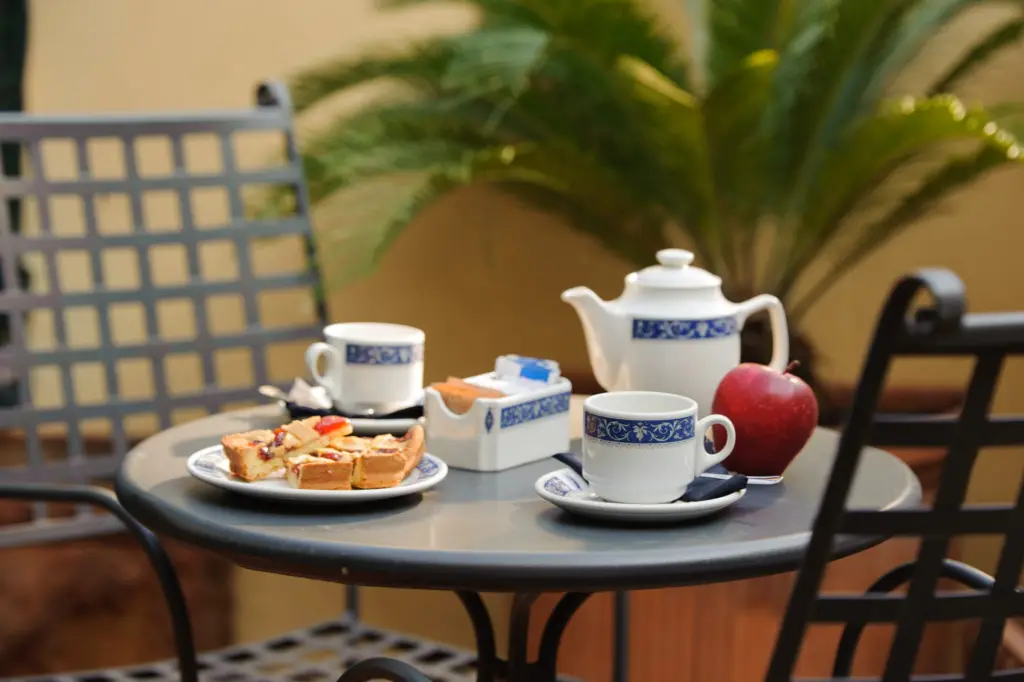 Tea set and pastries on a terrace table