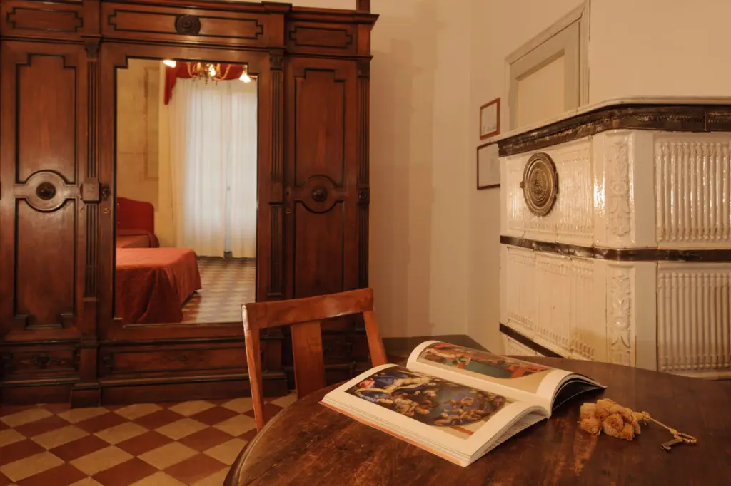 Suite with an antique wardrobe, a writing table and a ceramic stove