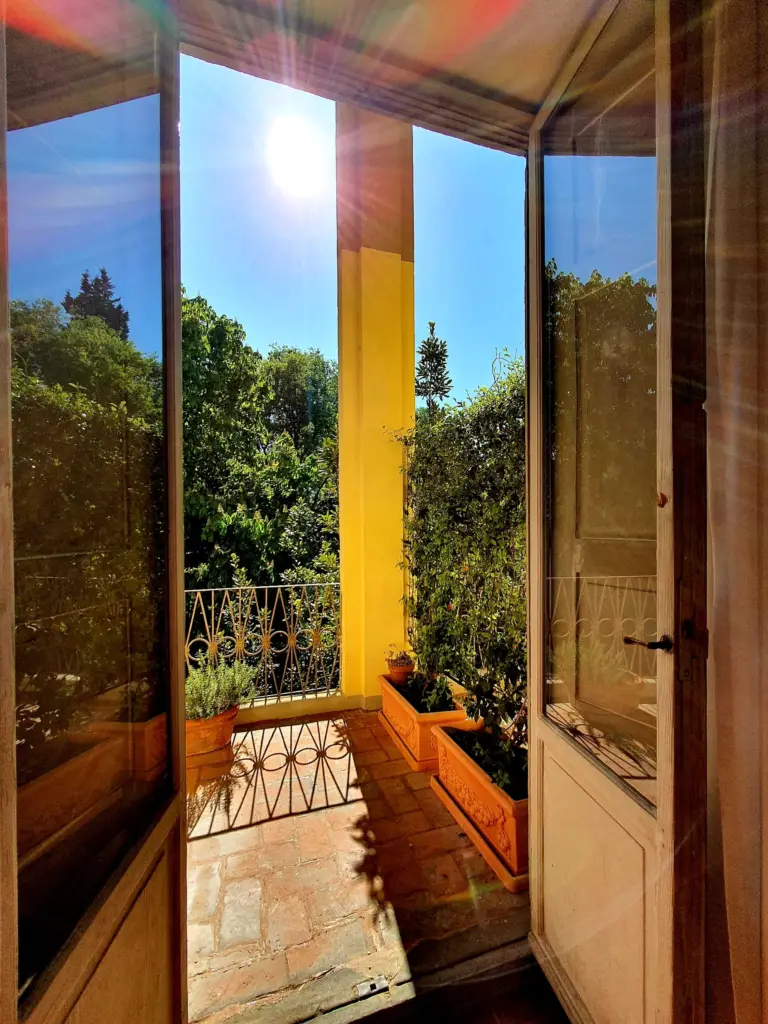 Balcony door of a single room open to the trees