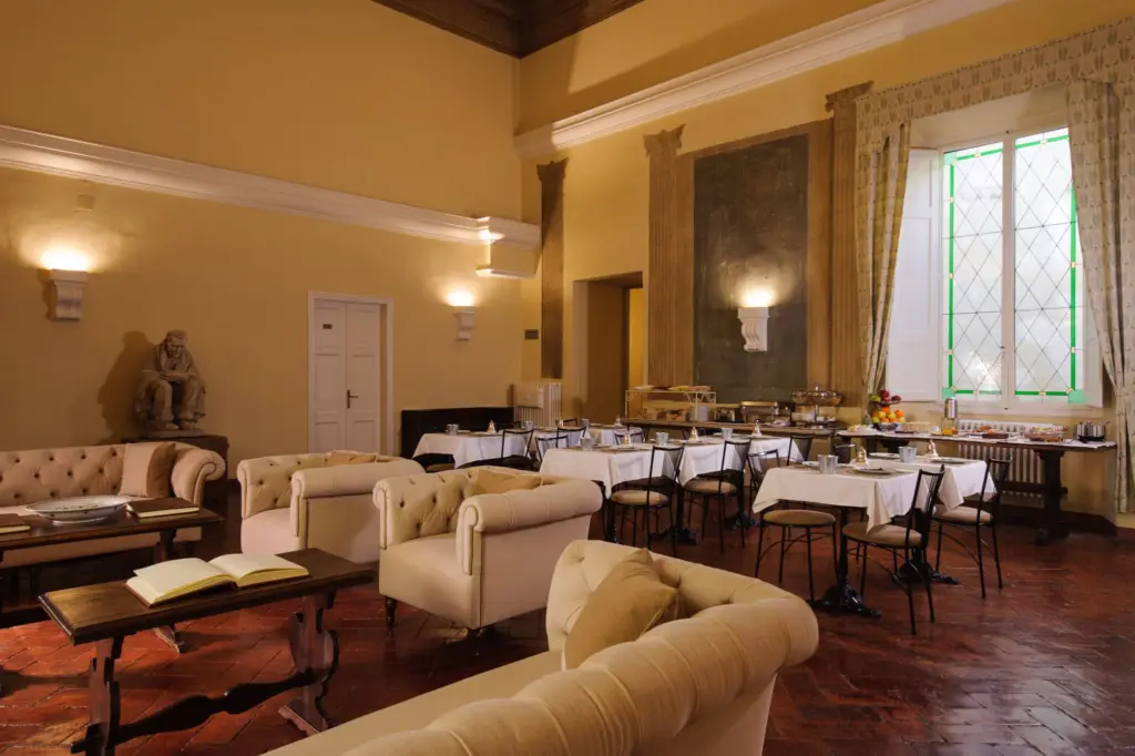 Cream sofas in the salon, with breakfast tables beyond